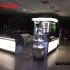 木质烤漆带玻璃化妆品柜台展示效果图
